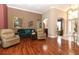 Large living room with hardwood floors, neutral paint colors, and archways leading to other rooms at 4201 Old Trafford Way, Orlando, FL 32810
