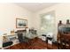 Bright office space with large windows, a glass desk, and hardwood floors at 4201 Old Trafford Way, Orlando, FL 32810