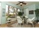 Enclosed patio has furniture, tile floors, and view of backyard landscaping at 4201 Old Trafford Way, Orlando, FL 32810