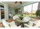 Comfortable screened patio with wicker furniture and tile floor, perfect for outdoor relaxation and entertaining at 4201 Old Trafford Way, Orlando, FL 32810