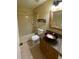 Bathroom featuring a vanity with a unique sink, toilet, shower-tub combo, and mirrored wall decor at 440 Martigues Dr, Kissimmee, FL 34759