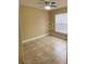 Simple bedroom with tile floors and natural light from the window at 440 Martigues Dr, Kissimmee, FL 34759