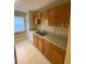 Functional kitchen featuring wood cabinets, laminate counters, and a double stainless steel sink at 440 Martigues Dr, Kissimmee, FL 34759