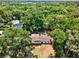An aerial view showcases the property's lush surroundings, mature trees, and private location at 474 Overstreet Ave, Longwood, FL 32750