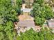 Aerial view of a home surrounded by lush landscaping and mature trees in a residential neighborhood at 474 Overstreet Ave, Longwood, FL 32750