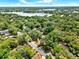 An aerial view highlighting the neighborhood and property's proximity to a lake surrounded by lush greenery at 474 Overstreet Ave, Longwood, FL 32750