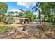 Spacious backyard with lush greenery, a wooden deck, and outdoor seating, perfect for entertaining and relaxation at 474 Overstreet Ave, Longwood, FL 32750