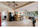 Spacious indoor bar area with refrigerator, bar, stools, and door to laundry room at 474 Overstreet Ave, Longwood, FL 32750