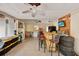 Spacious indoor bar area with bar, stools, mini fridge, television, and storage at 474 Overstreet Ave, Longwood, FL 32750