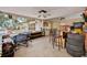 Spacious indoor bar area with bar, stools, table, chairs, storage, and screened patio at 474 Overstreet Ave, Longwood, FL 32750