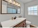 Well-lit bathroom featuring a large mirror, modern sink, and sleek fixtures at 474 Overstreet Ave, Longwood, FL 32750