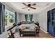 Comfortable bedroom with a ceiling fan, natural light, and wood-look tile flooring at 474 Overstreet Ave, Longwood, FL 32750