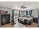 Cozy bedroom featuring a ceiling fan, natural light, and wooden-look tile floors at 474 Overstreet Ave, Longwood, FL 32750