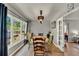 Sunlit dining room with backyard views, a charming table, and easy access to other rooms at 474 Overstreet Ave, Longwood, FL 32750