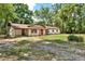 Cozy single-story home with a covered parking area, a well-manicured lawn, and an inviting curb appeal at 474 Overstreet Ave, Longwood, FL 32750