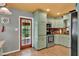 Cozy kitchen with stainless steel appliances, wooden countertops, and an adjacent doorway with backyard views at 474 Overstreet Ave, Longwood, FL 32750