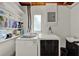 Bright laundry room features modern washer and dryer, convenient sink, and ample shelving for storage at 474 Overstreet Ave, Longwood, FL 32750