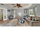 Inviting living room with a sectional sofa, wood flooring, and natural light, creating a warm atmosphere at 474 Overstreet Ave, Longwood, FL 32750