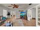 Comfortable living room featuring wood floors and access to other rooms and outdoor spaces at 474 Overstreet Ave, Longwood, FL 32750
