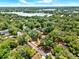 Aerial view with property lines of a lot near lake surrounded by trees and landscaping at 474 Overstreet Ave, Longwood, FL 32750