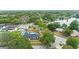 Aerial view of a charming home with a pool, surrounded by lush green trees and a serene lake nearby at 4804 Oakbrooke Pl, Orlando, FL 32812