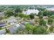 An aerial view showcasing a backyard pool and the nearby lake surrounded by mature trees at 4804 Oakbrooke Pl, Orlando, FL 32812