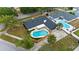 Aerial view of a charming home showcasing a modern backyard pool and mature landscaping at 4804 Oakbrooke Pl, Orlando, FL 32812