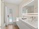 Modern bathroom with double vanity, stylish fixtures, and access to a backyard pool at 4804 Oakbrooke Pl, Orlando, FL 32812