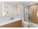 Modern bathroom features sleek vanity, large mirror and glass shower at 4804 Oakbrooke Pl, Orlando, FL 32812