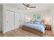 Bedroom with light wood floors, modern ceiling fan and dual closets at 4804 Oakbrooke Pl, Orlando, FL 32812