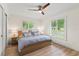Bright bedroom with modern ceiling fan, wood floors, and large windows at 4804 Oakbrooke Pl, Orlando, FL 32812
