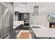 Modern kitchen with stainless steel appliances, gray cabinets, and white countertops with island and gas cooktop at 4804 Oakbrooke Pl, Orlando, FL 32812