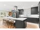 Open kitchen with stainless appliances, gray cabinets, large island with seating and white countertops at 4804 Oakbrooke Pl, Orlando, FL 32812