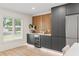 Modern kitchenette featuring wine refrigerator, grey cabinetry, and luxury countertop at 4804 Oakbrooke Pl, Orlando, FL 32812