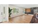 Open living space filled with natural light and modern kitchen and hard wood floors at 4804 Oakbrooke Pl, Orlando, FL 32812