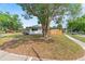 View of side yard with fenced in backyard and mature landscaping at 4804 Oakbrooke Pl, Orlando, FL 32812