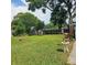 Large grassy backyard with a wooden fence and shed, perfect for outdoor activities and storage at 5005 Mill Stream Rd, Ocoee, FL 34761