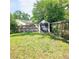 Spacious backyard featuring a storage shed with dark doors and lush green grass at 5005 Mill Stream Rd, Ocoee, FL 34761