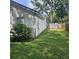 View of backyard space with healthy grass and a partial view of the home's siding at 5005 Mill Stream Rd, Ocoee, FL 34761