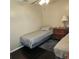 Simple bedroom with hardwood floors, two twin beds, and a ceiling fan at 5005 Mill Stream Rd, Ocoee, FL 34761