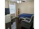 Cozy bedroom with dark wood floors, a small bookcase, and comfortable chair at 5005 Mill Stream Rd, Ocoee, FL 34761