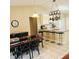 Open-concept dining area connected to the kitchen with ample lighting and space at 5005 Mill Stream Rd, Ocoee, FL 34761