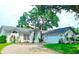 Charming single-story home with a well-manicured lawn, mature trees and a two car garage at 5005 Mill Stream Rd, Ocoee, FL 34761