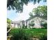 Inviting single-story home with green lawn and shade trees, providing a beautiful view at 5005 Mill Stream Rd, Ocoee, FL 34761