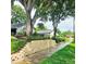 Charming home featuring lush landscaping and a quaint stone retaining wall along the sidewalk at 5005 Mill Stream Rd, Ocoee, FL 34761