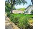 Landscaped front yard with vibrant greenery and a sidewalk view at 5005 Mill Stream Rd, Ocoee, FL 34761