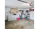 Functional garage space with ample storage including cabinets, shelving, and laundry appliances at 5005 Mill Stream Rd, Ocoee, FL 34761