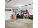 Spacious garage featuring a motorcycle, shelving, storage units, and ample room for parking and projects at 5005 Mill Stream Rd, Ocoee, FL 34761