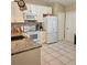Bright kitchen featuring granite countertops, white cabinetry, and stainless steel appliances at 5005 Mill Stream Rd, Ocoee, FL 34761
