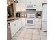 Updated kitchen with white cabinetry, granite countertops, and stainless steel appliances at 5005 Mill Stream Rd, Ocoee, FL 34761